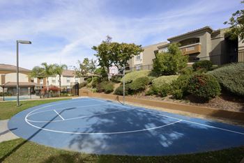 Basketball court in front of some apartments
